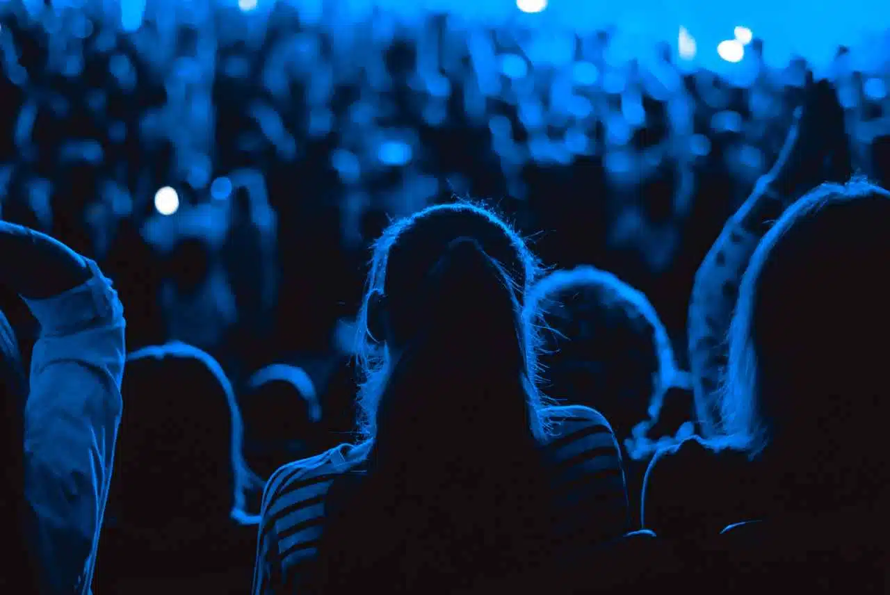 A blue toned dark photograph of an audience to depict seat fillers through OTLSeatFillers.com