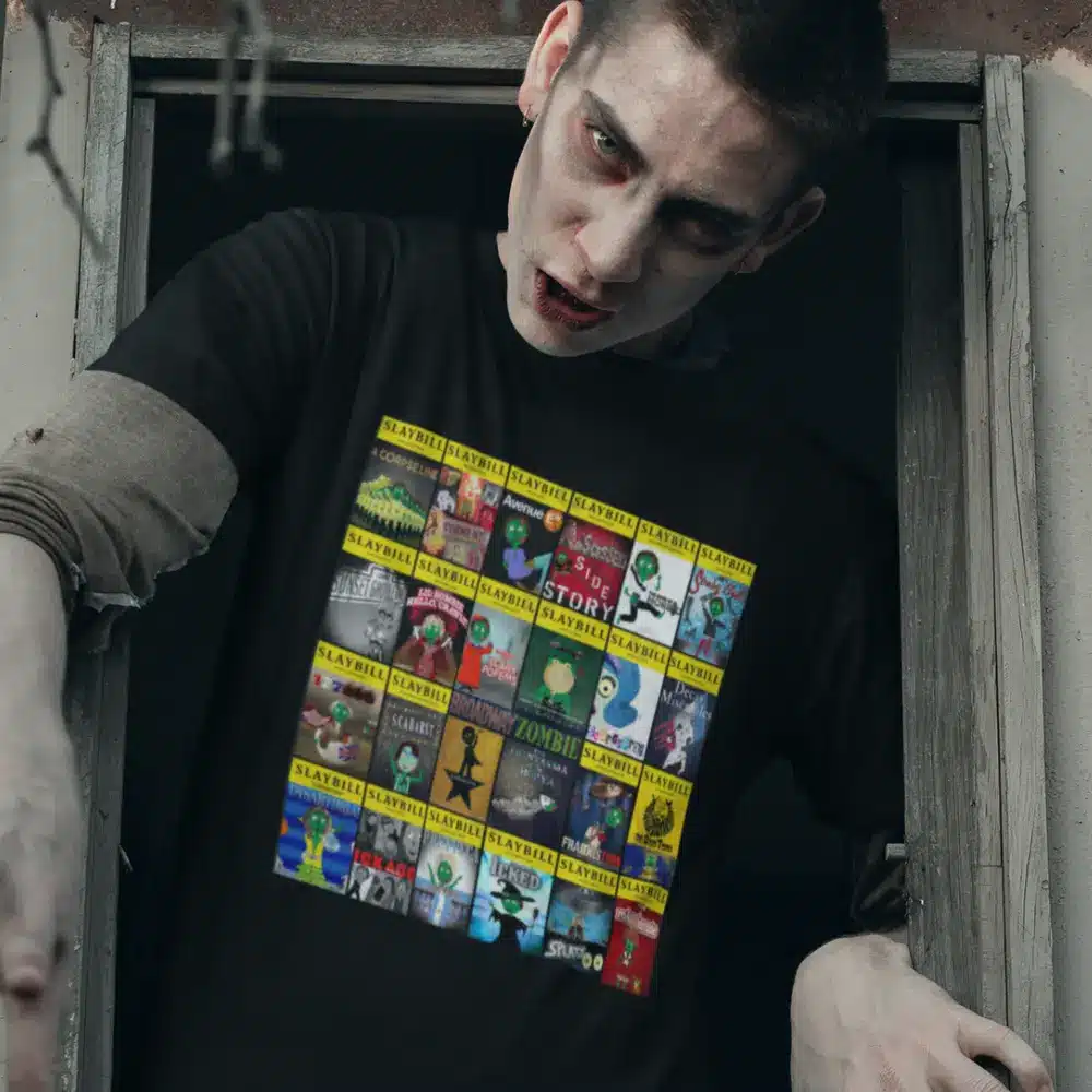 Person dressed as a zombie wearing a black t-shirt with a collage of "Slaybill" covers.