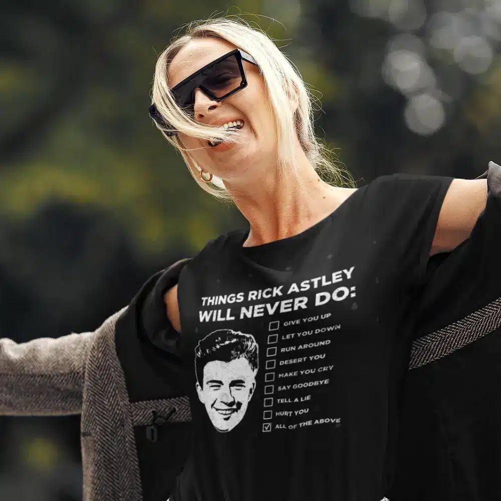 Woman wearing a black t-shirt with 'Things Rick Astley Will Never Do' design from the OTL Spotlight curated collection