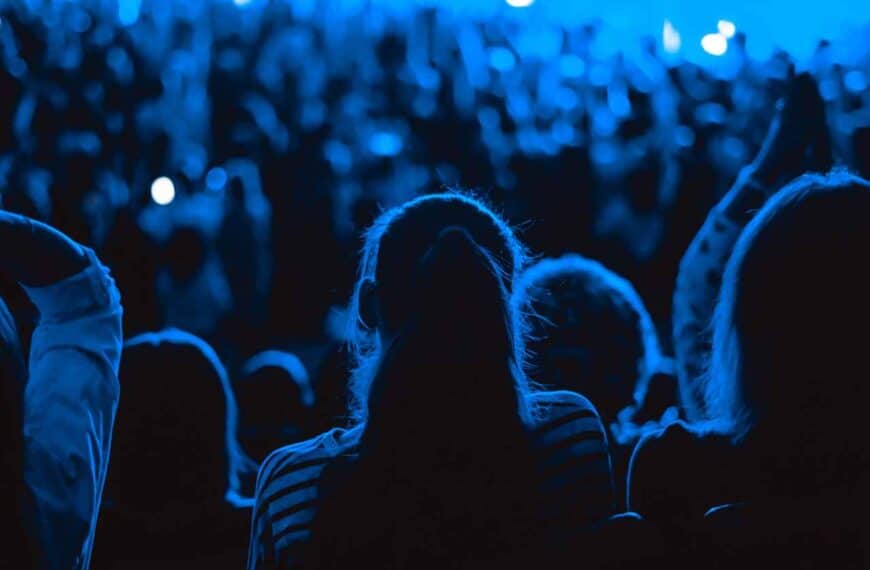 A blue toned dark photograph of an audience to depict seat fillers through OTLSeatFillers.com
