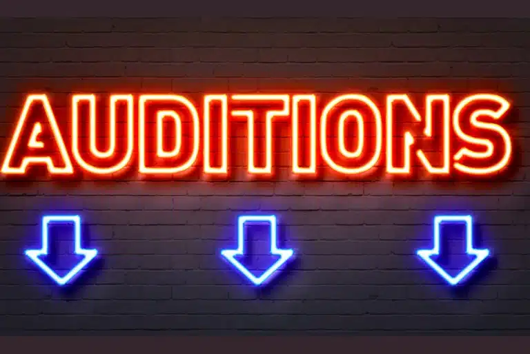 The word auditions in neon lights with downward facing arrows used to highlight the audition announcements page on OTL Seat Fillers.