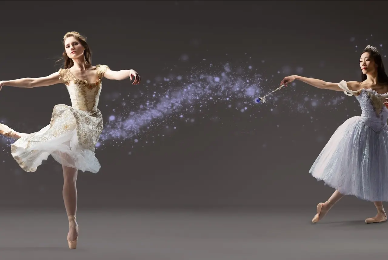 two ballerinas on a stage with fairy dust between them
