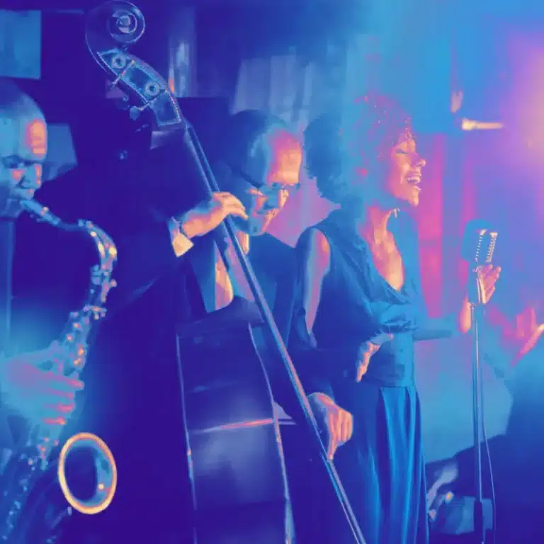 A jazz band in mid-performance, capturing a vocalist, a saxophonist, and a bass player, exemplifying the dynamic talent sought in band auditions
