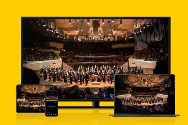 Multiple screens showing a live-streamed concert of the Berlin Philharmonic, depicting the accessibility and enjoyment of world-class performances through digital live streaming events.