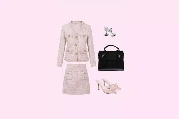 Women’s Legally Blonde theatre outfit with pink tweed skirt suit, white heels, handbag, and bow earrings.