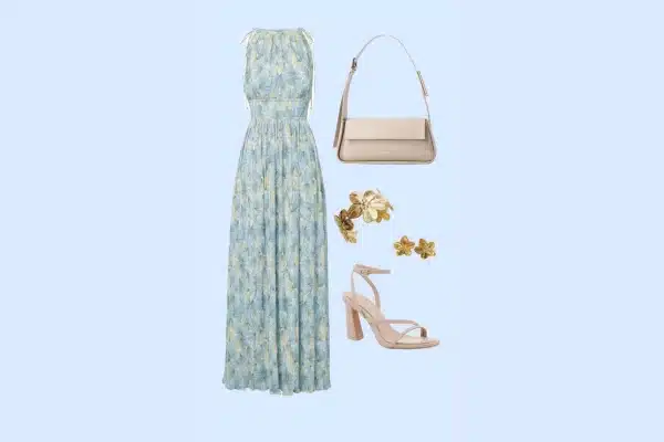 Women’s Mamma Mia theatre outfit with floral maxi dress, beige heels, handbag, and gold earrings.