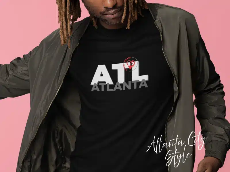 Model wearing black “ATL Atlanta” City Style tee with small heart logo—Atlanta gifts & local merch idea.