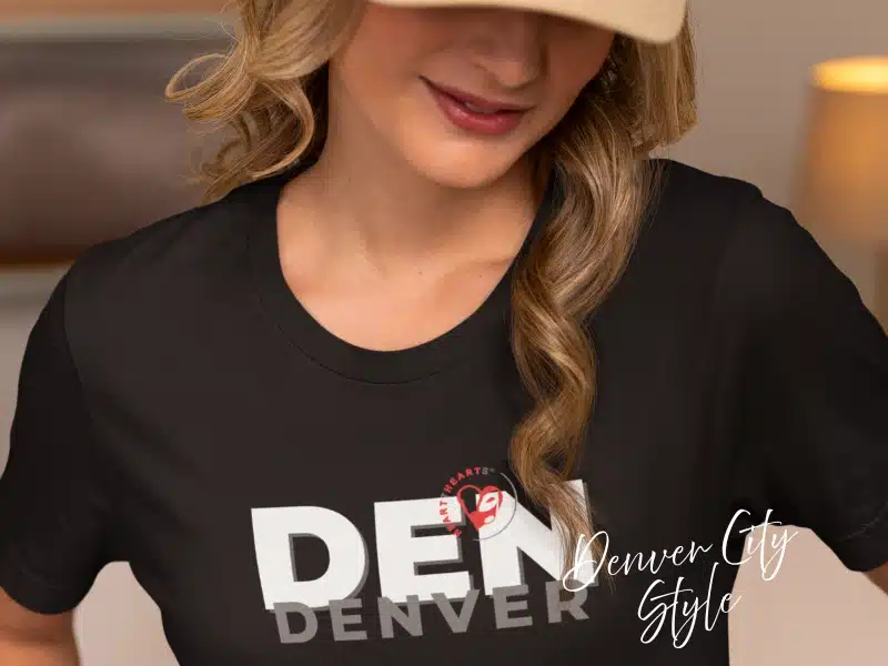 Model wearing black “DEN Denver” City Style tee—Denver gifts & local merch idea.