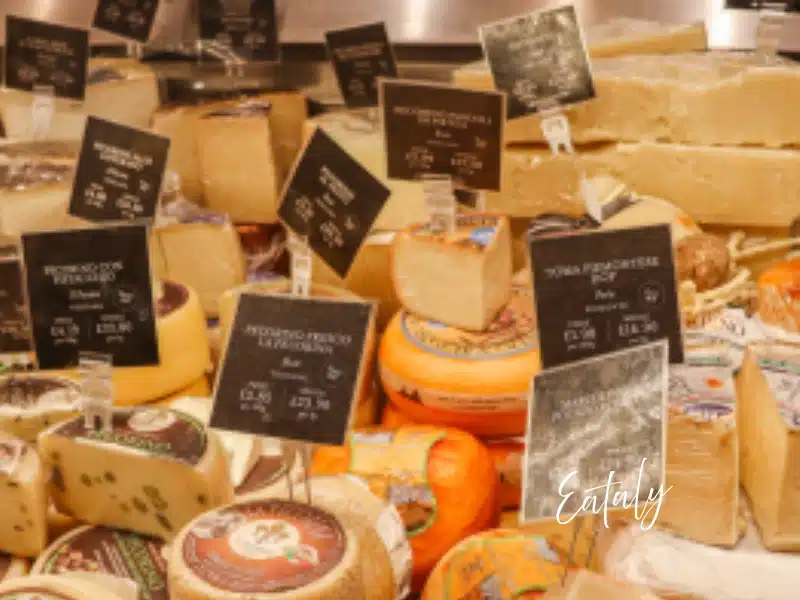 Eataly London cheese counter with wheels and wedges—London food gift idea and market gift card option.