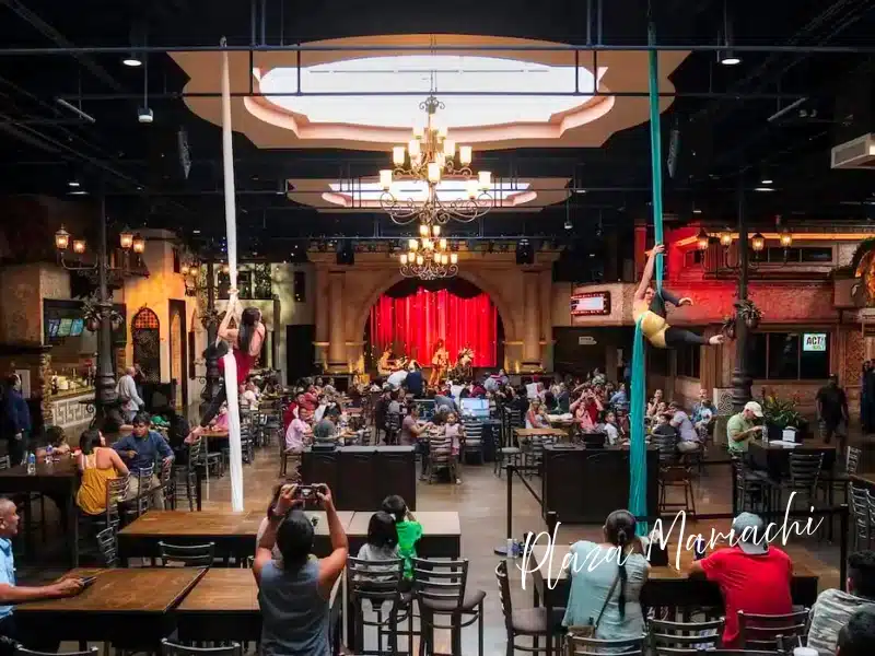 Plaza Mariachi Nashville—grand hall with aerial silk performers, live music stage, and dining tables; a lively Latin culture experience gift.