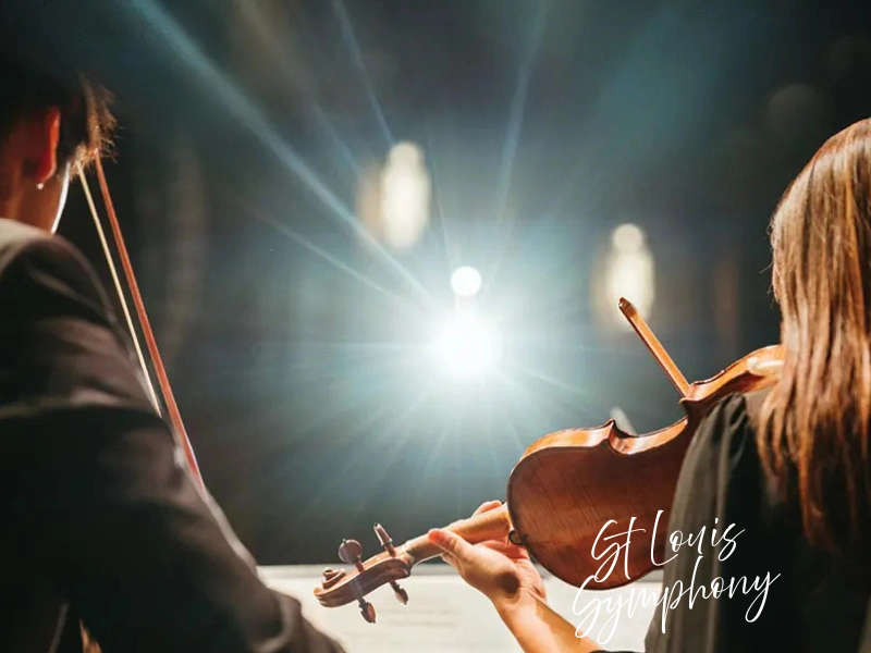 St. Louis Symphony musicians on stage with violins under concert lights, experience gift idea