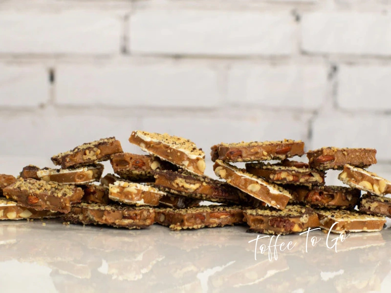 Stack of Toffee to Go chocolate-dipped almond toffee pieces, Tampa sweet gift