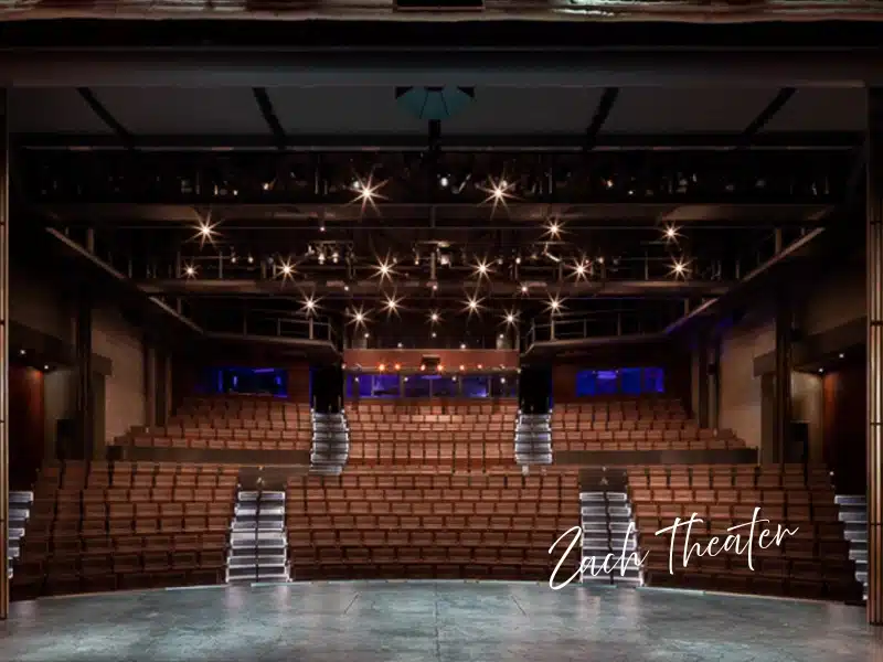 ZACH Theatre auditorium in Austin with glowing stage lights—Austin experience gift idea.