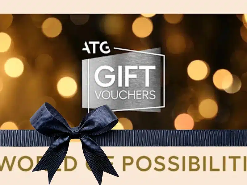 ATG theatre gift vouchers on a golden bokeh background — experience gift for theatre lovers.