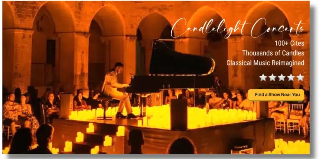Pianist at a grand piano surrounded by hundreds of candles in a stone-arched hall — Candlelight Concerts.