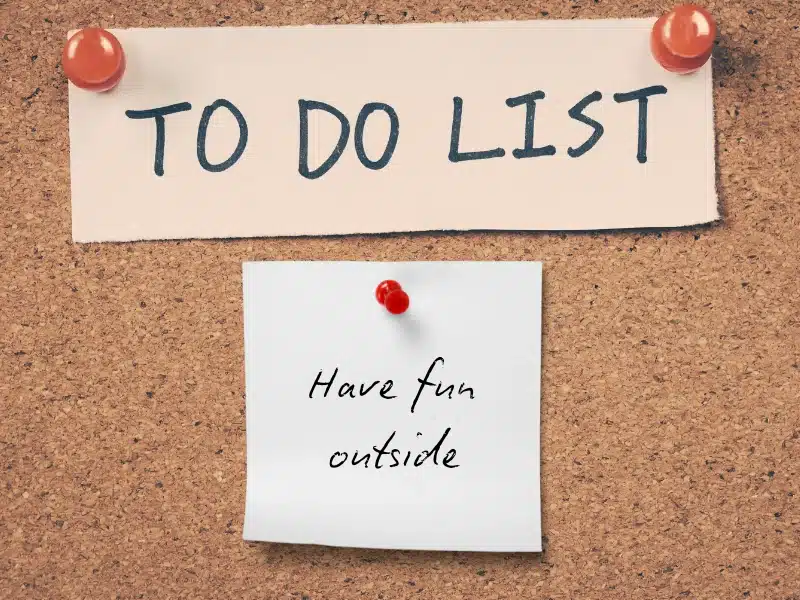 A "To Do List" on a corkboard with a sticky note that reads "Enjoy the outdoors."