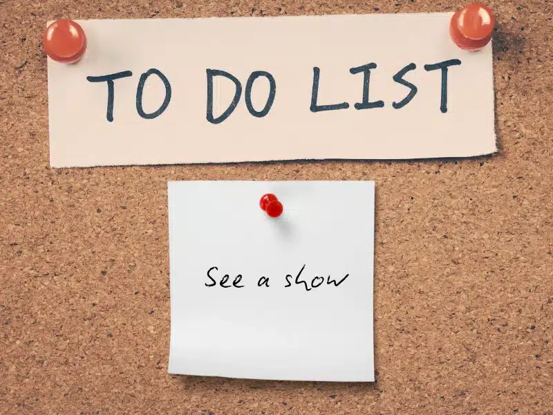 A "To Do List" on a corkboard with a sticky note that reads "See a show."