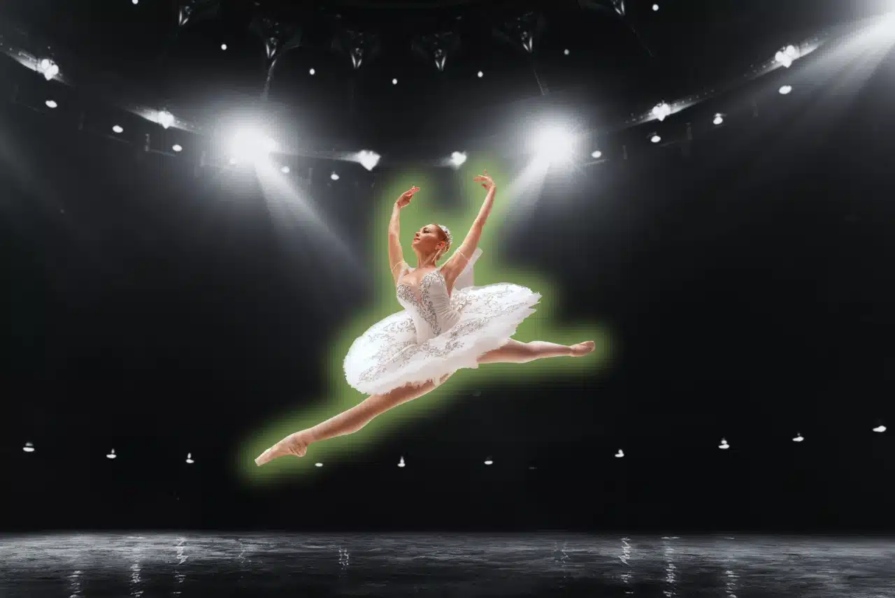 Jumping ballerina in a white tutu performing on stage for the Ultimate Guide to Ballet blog post on OTL Seat Fillers.