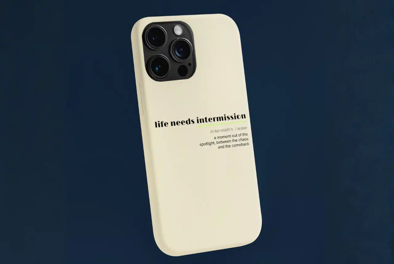 Life Needs Intermission Busy Life Edition cream phone case with definition-style text on a dark blue background.