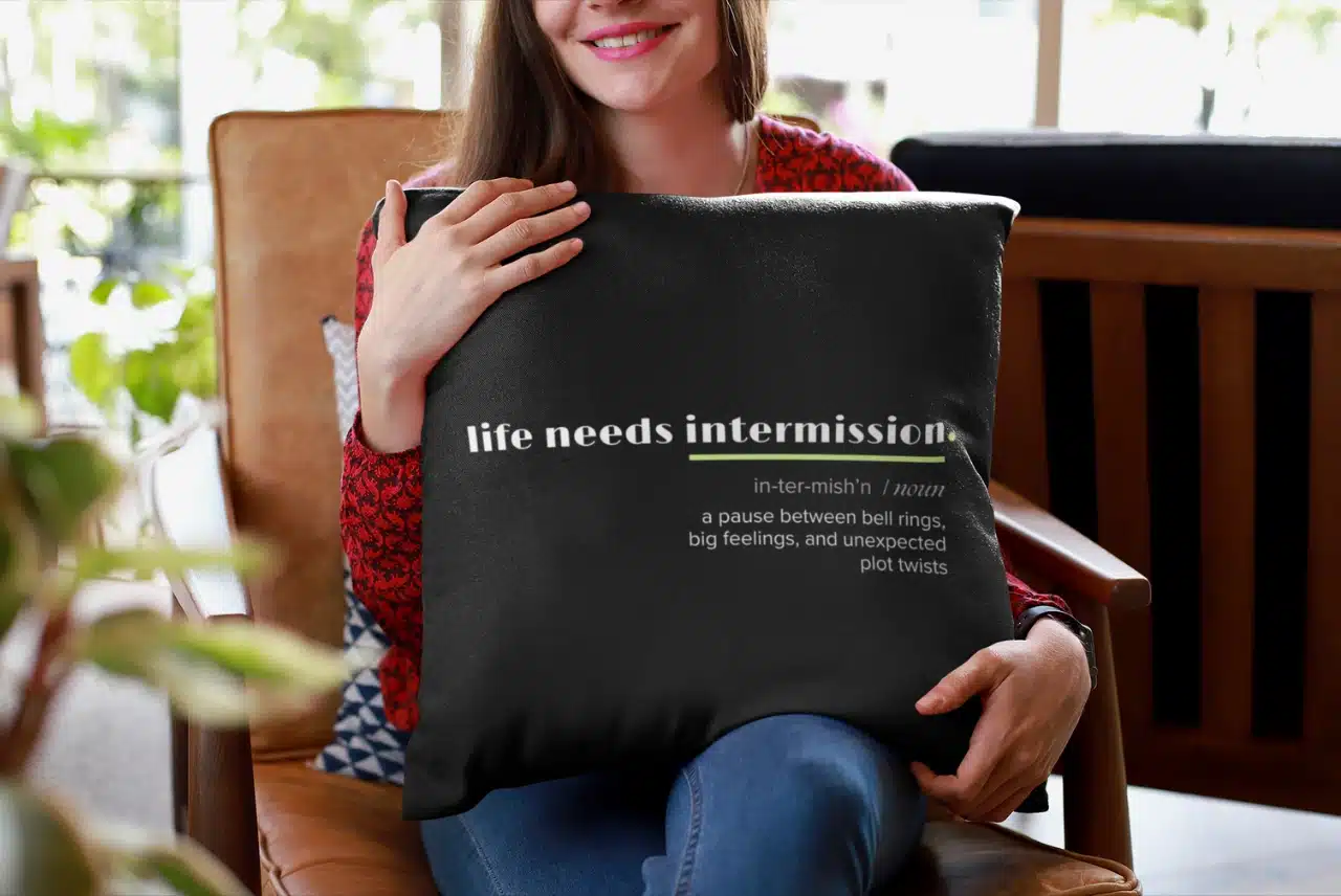 Life Needs Intermission Teacher Edition black throw pillow with definition-style classroom humor.
