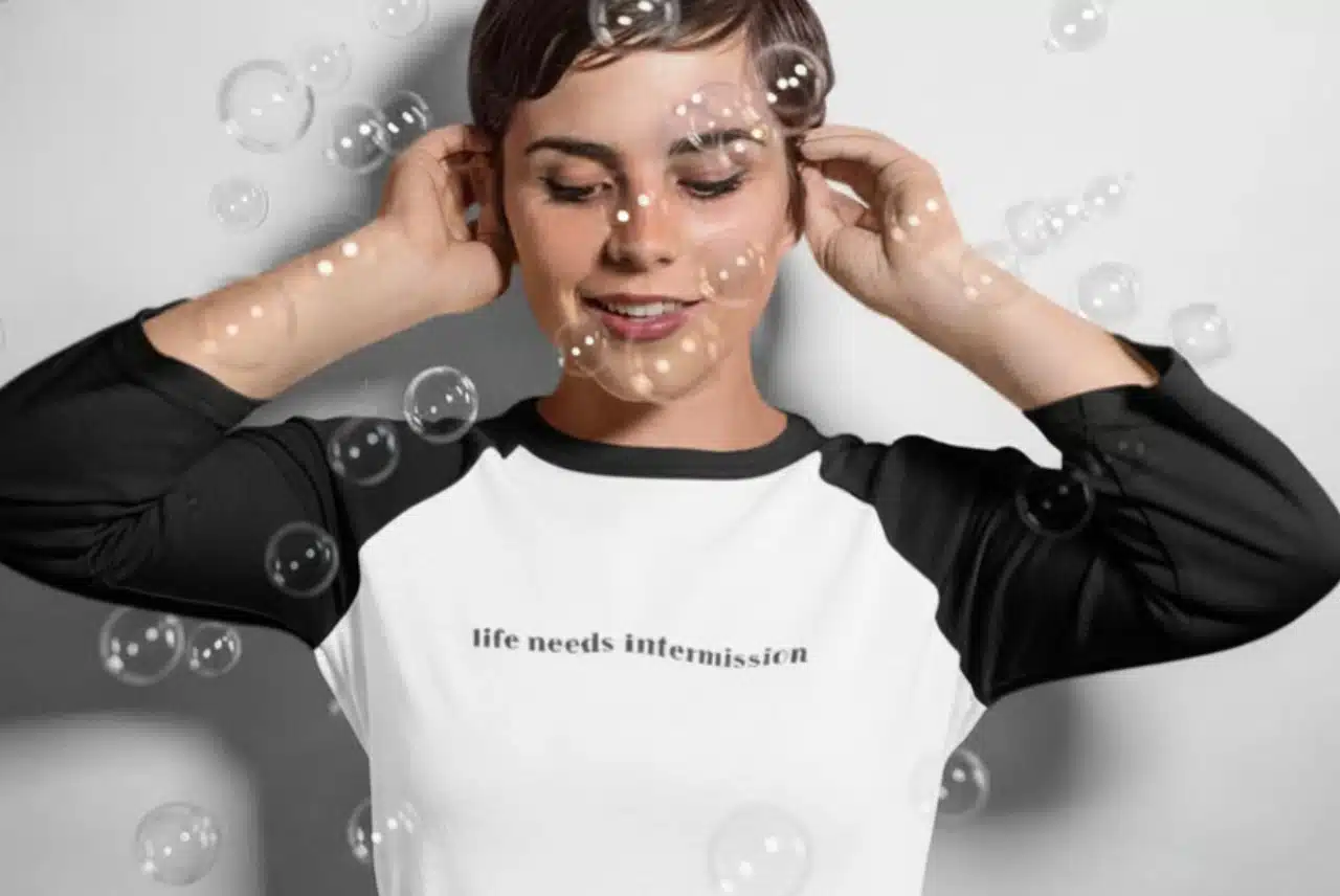 Life Needs Intermission baseball shirt with dark sleeves and text on the front.
