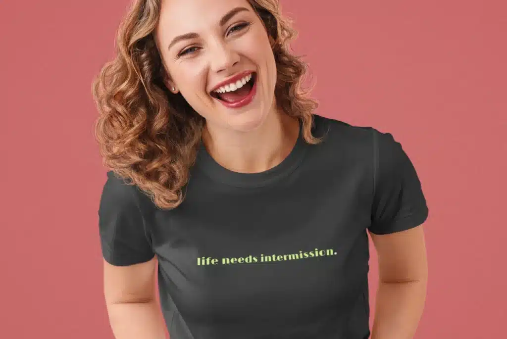 Life Needs Intermission dark t-shirt with green text on the front.
