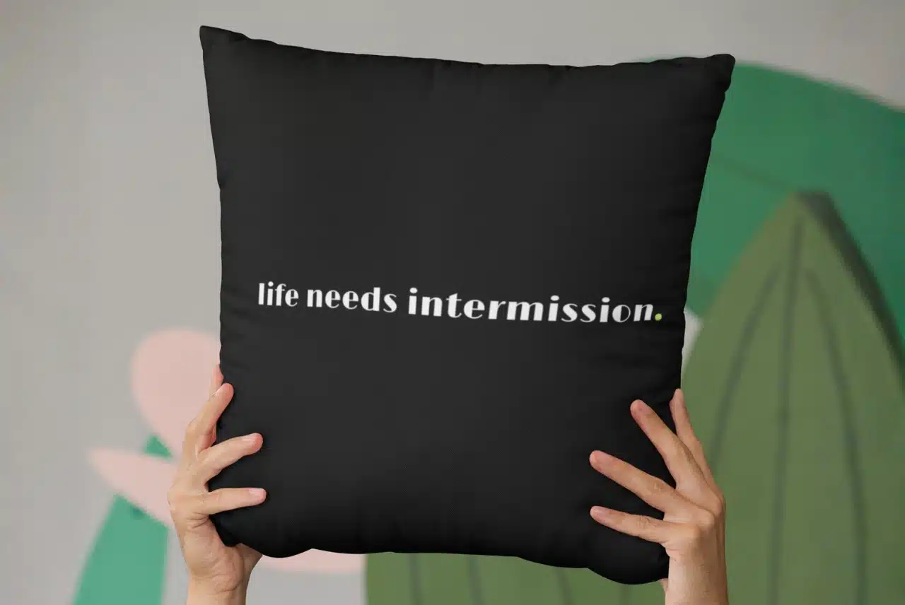Life Needs Intermission decorative pillow with the text design on the front.
