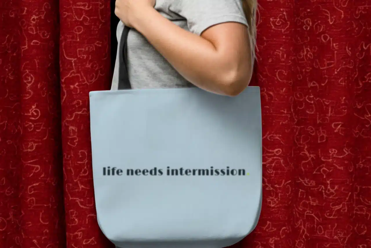 Life Needs Intermission tote bag with the design on the front.