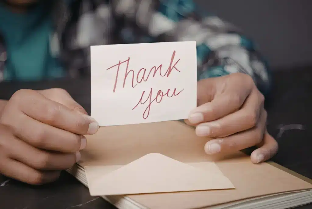 Military Appreciation Gifts image with hands holding a thank-you note over an envelope.
