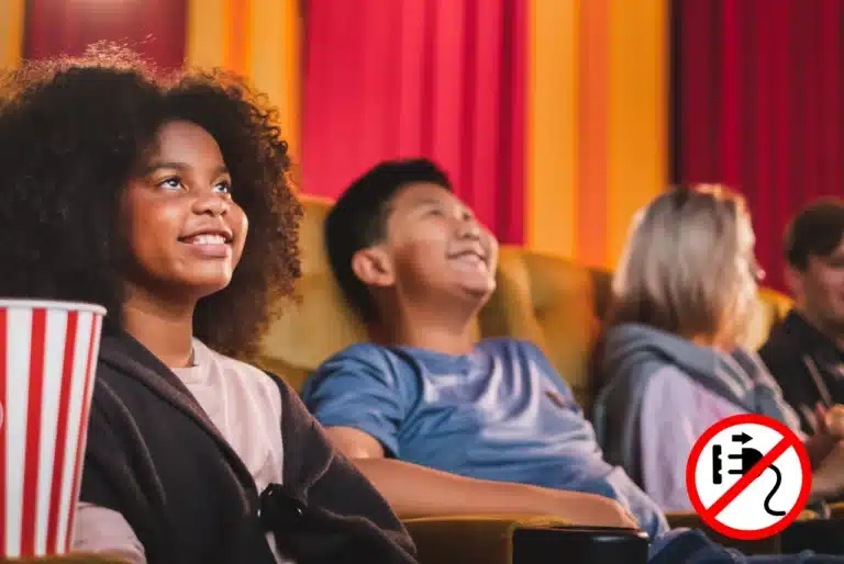 Family friendly events near me with children smiling in a theatre audience and a no-phone icon in the corner.