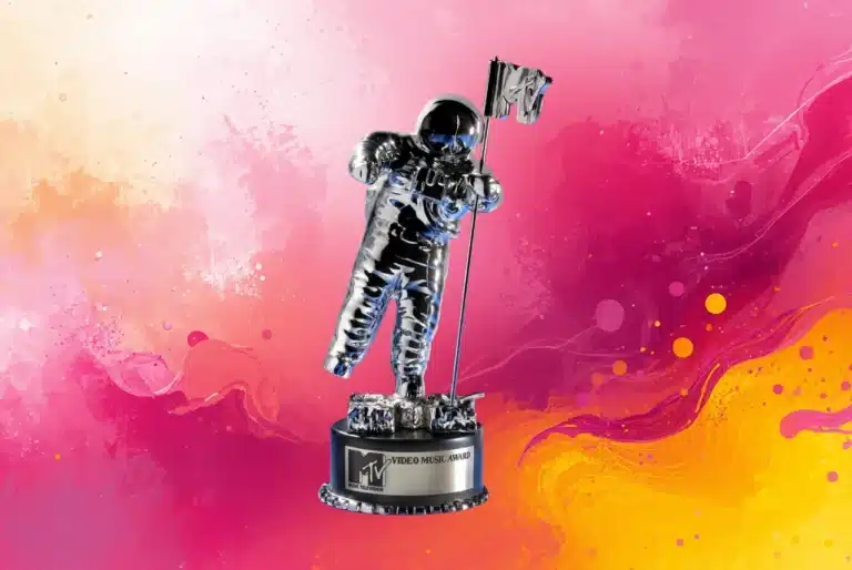 Silver Moon Person-style music award statue against a bright pink, orange, and yellow splash-art background.