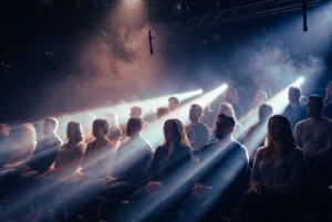 Studio audience seated under bright stage lights during a television taping.